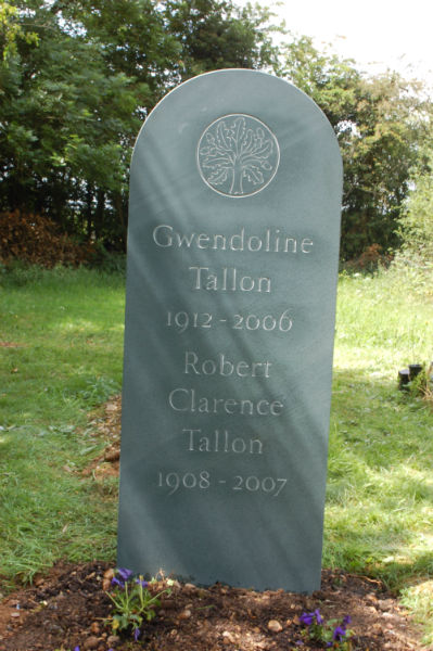 green slate headstone with oak tree carving